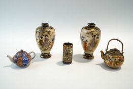 A collection of miniature Satsuma ware, including a pair of vases, teapot, a cylindrical pot,