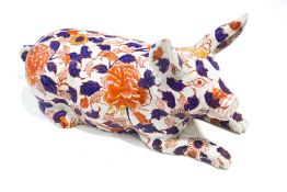 A Japanese pottery figure of a pig,