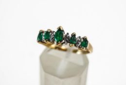 An emerald and diamond ring, stamped '10K',