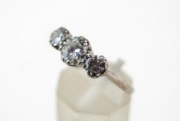 A three stone diamond ring, the white mount with sizing beads now covering original marks,