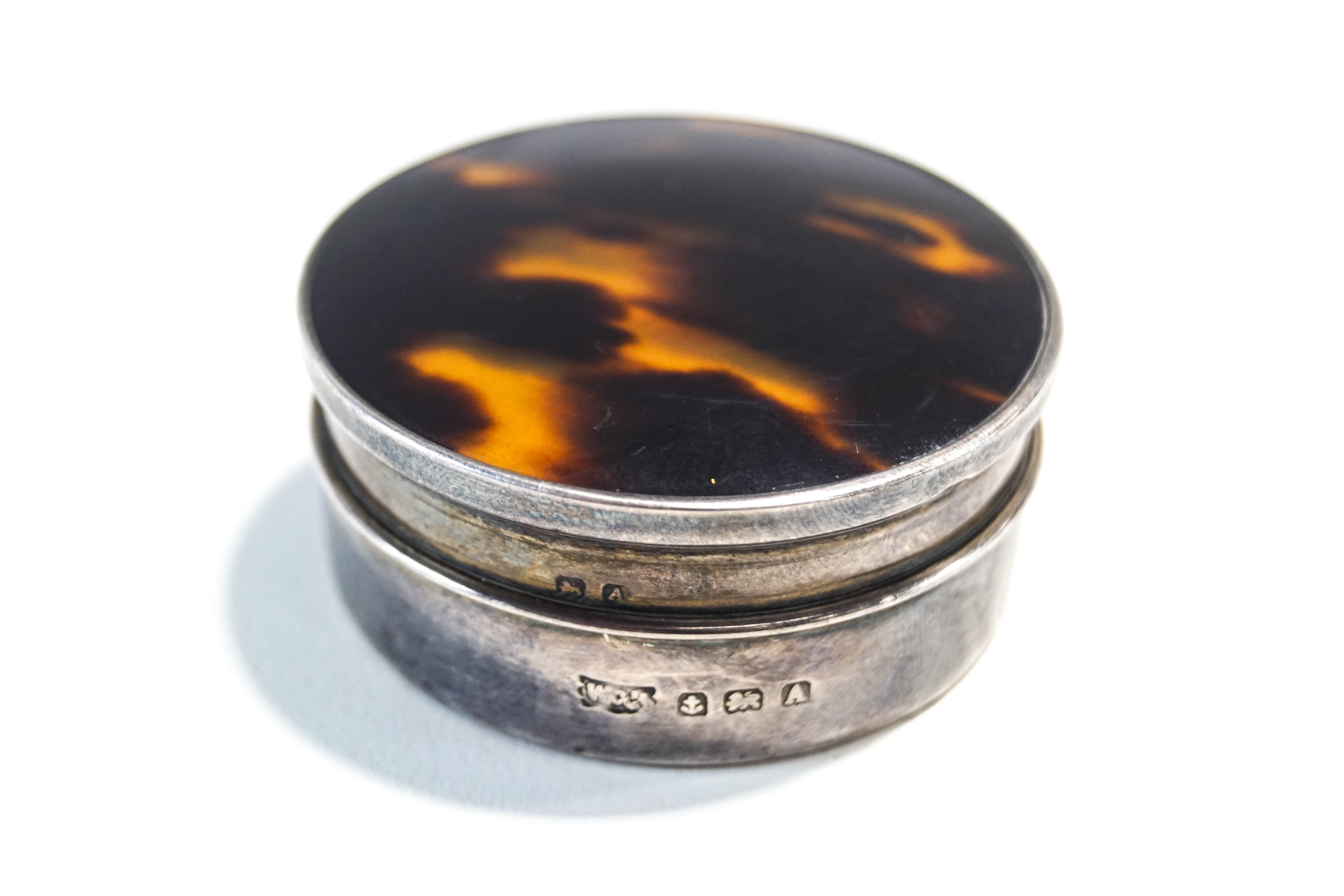 A silver and tortoise shell box, Birmingham 1925, circular with pull off cover, 5.