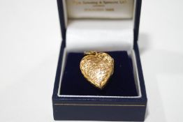 An early 20th Century gold plated locket, containing the photograph and hair of Charles Nash,