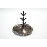 A silver ring tree, by Walker & Hall, Birmingham 1902, the circular base with pierced rococo border,