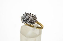 A 9 carat gold twenty nine stone diamond cluster ring, the brilliant cuts totalling approximately 0.