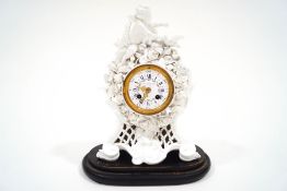 A porcelain mantel clock with white enamel dial signed Howell James & Co.