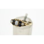 A 9 carat gold opal and sapphire dress ring, finger size O, 1.