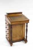 A 19th Century walnut Davenport, with lidded compartmental storage area,