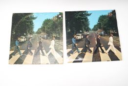 Two Beatles Abbey Road vinyl records.