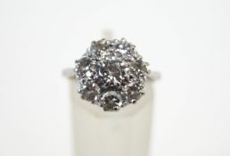 An eight stone diamond cluster ring, stamped '18ct' and 'Plat',