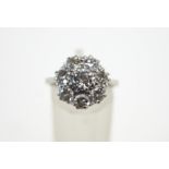 An eight stone diamond cluster ring, stamped '18ct' and 'Plat',