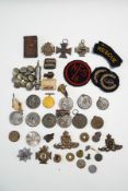 A collection of Military badges, buttons, commemorative a policeman's whistle etc.