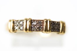 A diamond set dress ring, stamped '375', set with three quartets of single cut diamonds,