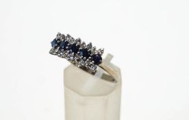 A sapphire and diamond ring, the white mount stamped '18ct',
