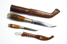 Two Finnish daggers in leather sheaths,