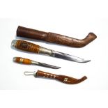 Two Finnish daggers in leather sheaths,