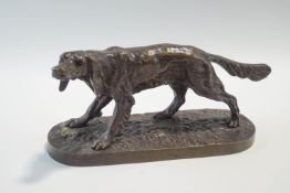 A bronze sculpture of a dog, in a hunting pose,