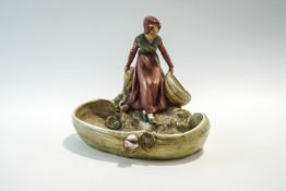 A Royal Dux Art Nouveau dish, modelled with a girl collecting water, impressed marks to base,