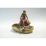 A Royal Dux Art Nouveau dish, modelled with a girl collecting water, impressed marks to base,