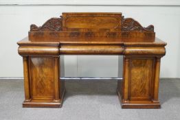 A Victorian flame mahogany pedestal sideboard, with three drawers and twin cupboards,