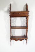 A reproduction mahogany wall shelf, in the Chippendale style,