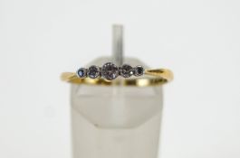 A five stone diamond ring, stamped '18ct', the graduated old brilliant and single cuts,