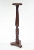 A Victorian style mahogany torchere, the reeded and spiral carved column on a tri-form base,