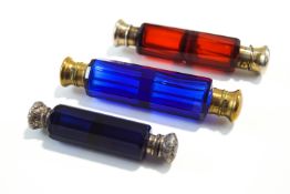 Two Victorian double ended coloured glass scent bottles, with plated mounts, and a smaller example,