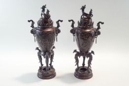 A pair of early 20th Century Japanese bronze vases and covers,