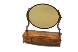 A Georgian mahogany dressing table mirror, the bow fronted base with three drawers,