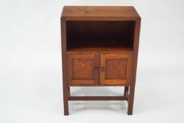 An early 20th century Cotswold style oak side cabinet, 53cm wide x 78cm high x 27.