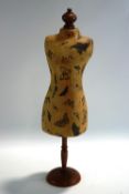 A small vintage shop display dummy, paper mache body on a turned wood stand,