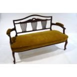 A Victorian mahogany salon settee, with decorative triple splat back,