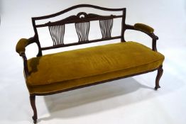 A Victorian mahogany salon settee, with decorative triple splat back,