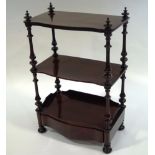 A Victorian rosewood whatnot, with three shaped tiers, turned supports and drawer to base,