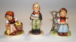 Three Hummel figures : Seated girl with chicks, Singing boy,