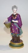 A 19th century Meissen style figure of a lady in chinoiserie dress holding a basket and a flower,