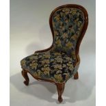 A Victorian mahogany spoon back salon chair, with button back upholstery,