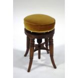 A 19th Century mahogany piano stool with turned and reeded splayed legs,