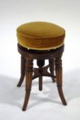 A 19th Century mahogany piano stool with turned and reeded splayed legs,