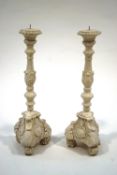 A pair of 18th Century pricket style candlesticks, painted white,