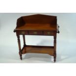 A Victorian mahogany wash stand, with side hanging rails and under tier shelf,