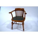 A 20th Century oak armchair, with shaped stick back, scroll arms and turned legs,