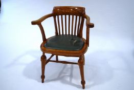A 20th Century oak armchair, with shaped stick back, scroll arms and turned legs,