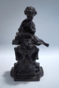 A 20th Century bronze of a seated girl reading,