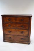 A Victorian mahogany chest of three long drawers with faux draw front and enclosed sliding shelves