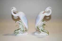 A pair of modern Continental porcelain bookends, modelled as crane, weighted,