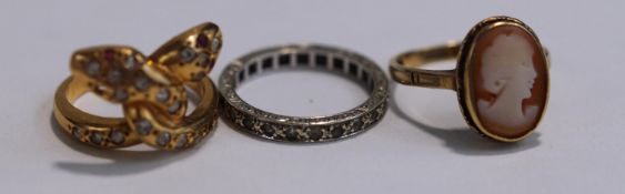 A stone set double serpent ring, of cross over design, with Egyptian control marks,