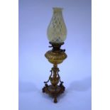 A Victorian oil lamp by Evered & Co Ltd, the gilt metal column and reservoir with classical detail,