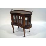A 20th Century mahogany tray top display cabinet, of kidney shape,