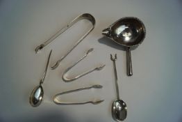 A pair of Georgian silver sugar tongs; two smaller later silver sugar tongs;